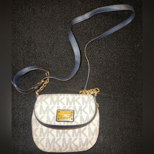 Michael Kors Coated Canvas crossbody in navy blue and white with gold hardware.